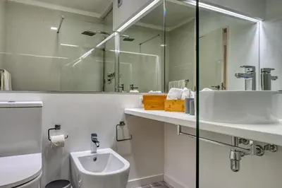 a bathroom with a toilet and a sink and a shower at Maranta House, a Home in Madeira in Funchal