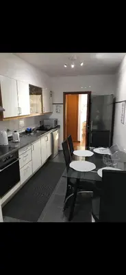 a kitchen with a table and a dining room at O lagar in Câmara de Lobos