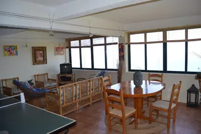 a living room with a table and chairs at Casal São João Cottages in Fajã da Ovelha