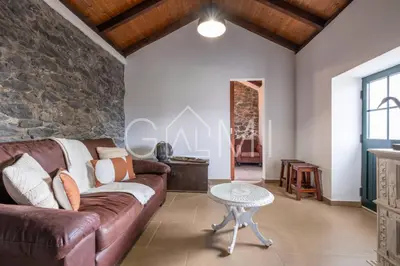 a living room with a couch and a table at Casa do Maurício by GALMI in Ponta do Pargo