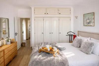 a bedroom with a bed with a tray of fruit on it at Dreamy Sea View Apartment with Access to Private Pool & Stunning Rooftop in Luz