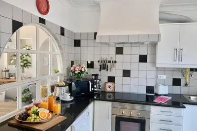 a kitchen with a bowl of fruit on a counter at Dreamy Sea View Apartment with Access to Private Pool & Stunning Rooftop in Luz