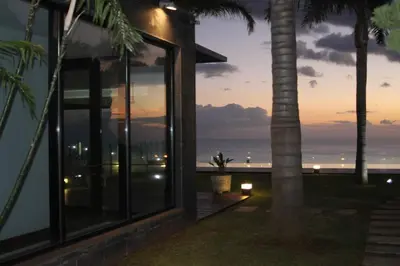 a house with a view of the ocean at sunset at Super luxury villa Views and panoramic lift in Funchal
