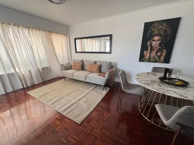 a living room with a couch and a table at Infante Home in Funchal