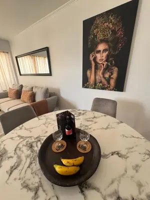 a table with bananas and wine glasses on it at Infante Home in Funchal