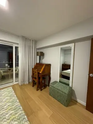 a bedroom with a desk and a chair and a mirror at Infante Home in Funchal
