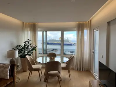 a dining room with a view of a cruise ship at Infante Home in Funchal