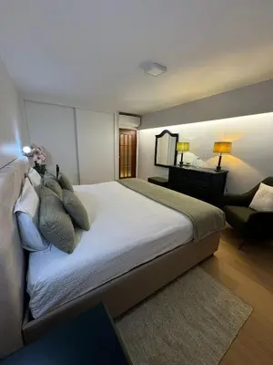 a bedroom with a large bed and a desk at Infante Home in Funchal