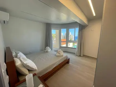 a bedroom with a bed and a large window at Luxurious T2 Varandas Apartment XIII in Funchal
