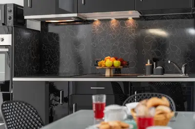 a kitchen with a table with a bowl of fruit at Apartamento América II by An Island Apart in Funchal