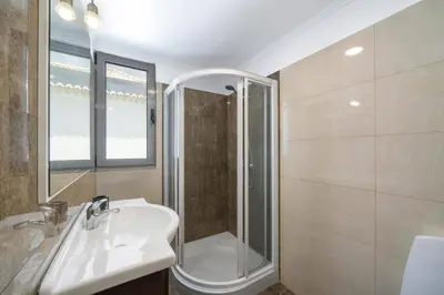 a bathroom with a sink and a shower at Villa Atlantic Sunrise by Villa Plus in Funchal