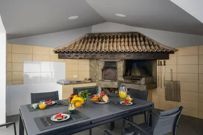a table with food on it in a kitchen with a fireplace at Villa Atlantic Sunrise by Villa Plus in Funchal