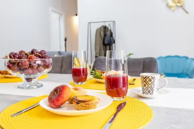 a table with a plate of food and a bowl of fruit at Magalhães AL by YOUR KEY MADEIRA in Machico