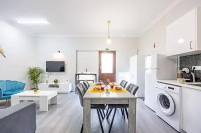 a kitchen and living room with a table and chairs at Magalhães AL by YOUR KEY MADEIRA in Machico