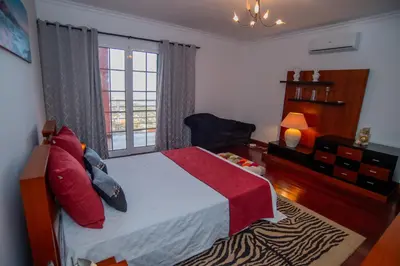a bedroom with a large bed and a window at Countesses Villa in Câmara de Lobos