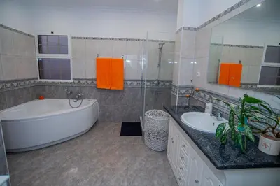 a bathroom with a tub and a sink and a bath tub at Countesses Villa in Câmara de Lobos