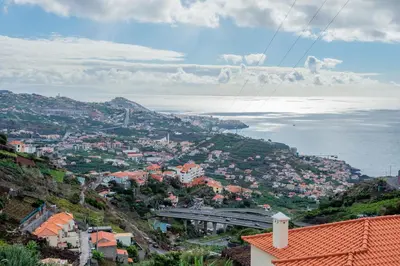 a town on a hill with the ocean in the background at Countesses Villa in Câmara de Lobos