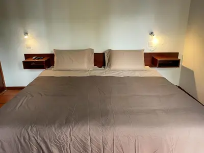 a large bed with two pillows in a room at Habitación santo antonio in Estrela