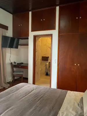 a bedroom with a bed and a room with a desk at Habitación santo antonio in Estrela