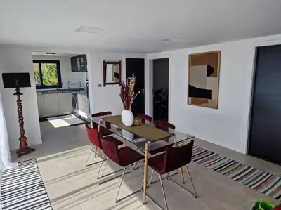 a dining table and chairs in a living room at Casa Vieira in Fajã da Ovelha