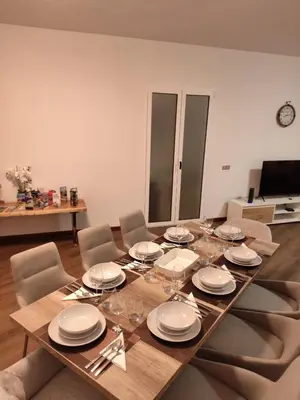 a dining room table with plates and wine glasses at Villa São João in Funchal
