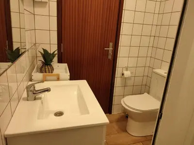 a white bathroom with a sink and a mirror at Villa São João in Funchal