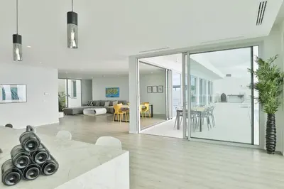 a living room and dining room with sliding glass doors at Villa Noelia Ocean View in Prazeres