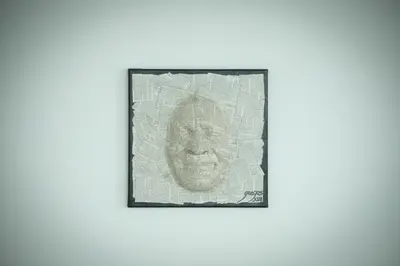 a drawing of a mask on a newspaper at Villa Noelia Ocean View in Prazeres