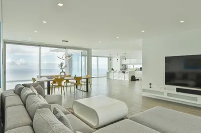 a living room with a large couch and a table at Villa Noelia Ocean View in Prazeres