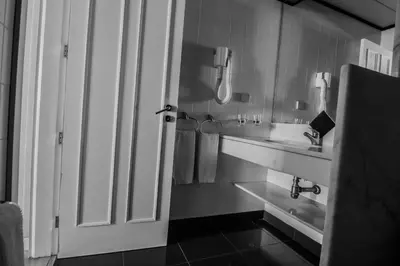 a bedroom with a large bed and a window at Apartamentos Turisticos Avenue Park in Funchal
