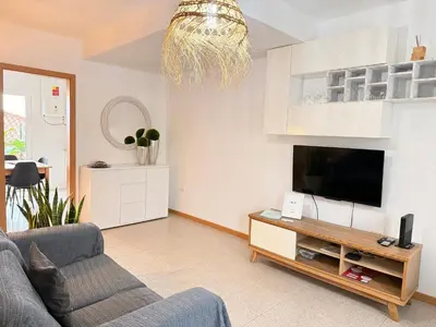 a living room with a couch and a flat screen tv at Zezita's Place in São Jorge