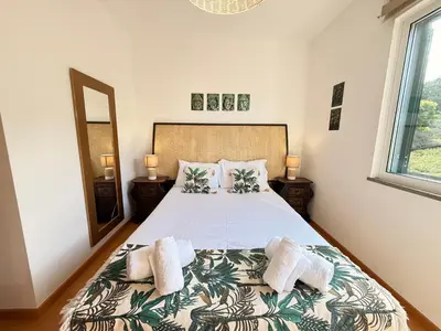 a bedroom with a bed with two towels on it at Zezita's Place in São Jorge