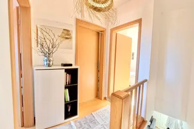 a hallway with a white refrigerator and a mirror at Zezita's Place in São Jorge