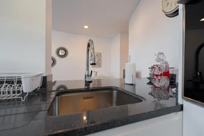 a kitchen with a sink and a counter top at VIP Baía Beach in Machico