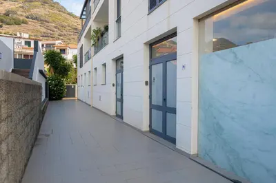 an empty hallway of a building with a walkway at VIP Baía Beach in Machico