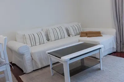 a white couch with pillows and a table in a living room at Formosa Beach Apartment Vista Mar a 2 Minutos da Praia in Funchal