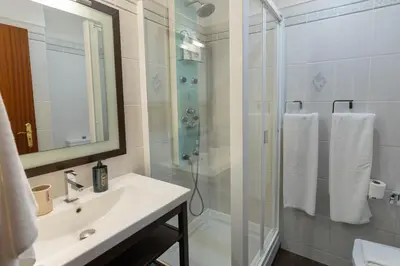 a bathroom with a sink and a shower with a glass door at Formosa Beach Apartment Vista Mar a 2 Minutos da Praia in Funchal