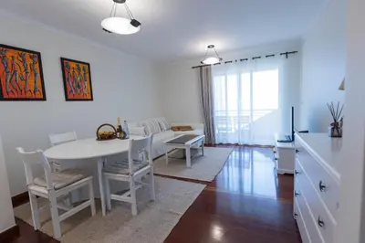 a kitchen and dining room with a table and chairs at Formosa Beach Apartment Vista Mar a 2 Minutos da Praia in Funchal