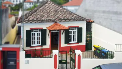 a model of a house is on the side of a building at Funchal Bartolomeu Explorers in Funchal