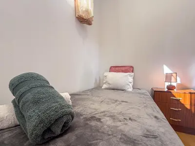 a small room with a bed and a chair at Funchal Bartolomeu Explorers in Funchal