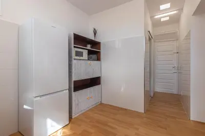 a kitchen with white cabinets and a refrigerator at Funchal Bartolomeu Explorers in Funchal