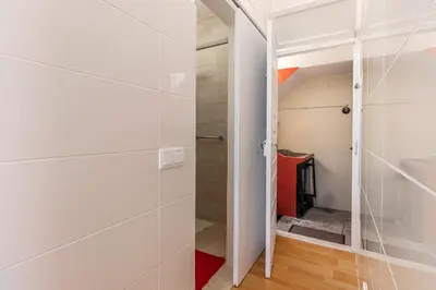 a walk in closet with white walls and a glass door at Funchal Bartolomeu Explorers in Funchal