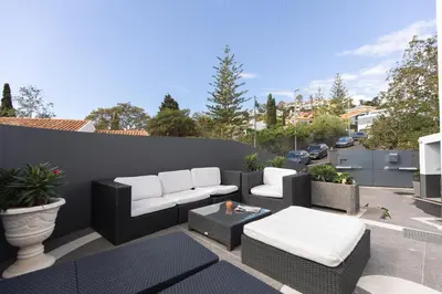 a patio with two couches and a coffee table at Vila Margot by Rent-a-key in Caniço