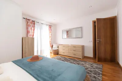 a bedroom with a bed with a hat on it at Vila Margot by Rent-a-key in Caniço