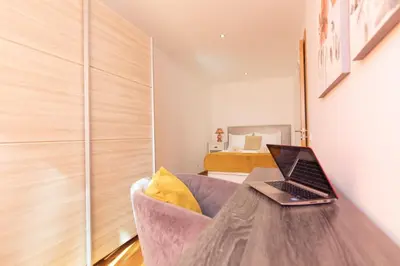 a laptop computer sitting on a wooden table in a room at Vila Margot by Rent-a-key in Caniço