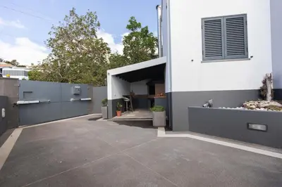 a garage entrance to a house with a driveway at Vila Margot by Rent-a-key in Caniço