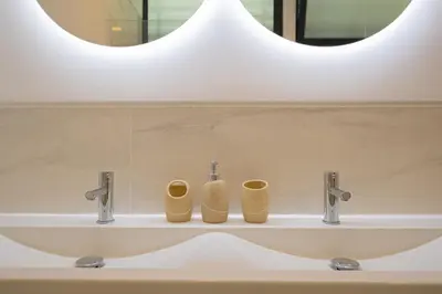 a bathroom sink with two towels sitting on it at VIP Baía Beach C in Machico