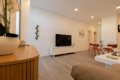 a living room with a flat screen tv on a white cabinet at VIP Baía Beach C in Machico
