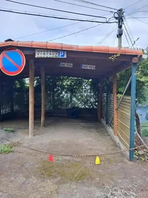 a gas station with a blue sign and orange cones at Casa Vintage Seixal Madeira in Seixal