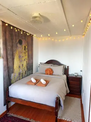 a bedroom with a bed with two towels on it at Casa Vintage Seixal Madeira in Seixal